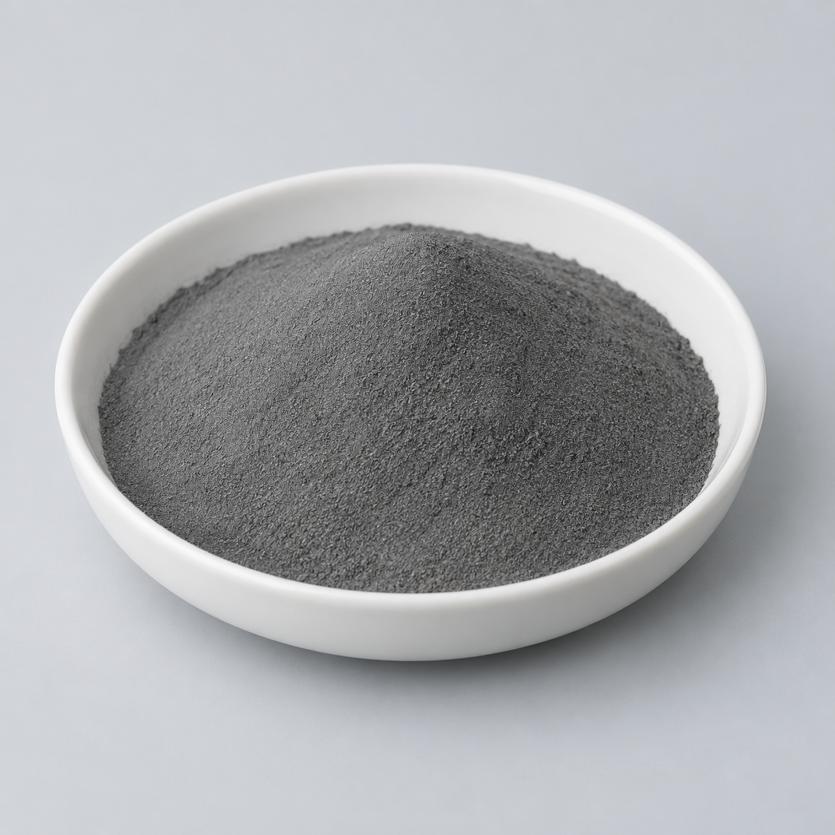 Representative image of CoCrFeNi High-Entropy Alloy Spherical Powder: fine medium-dark gray CoCrFeNi alloy powder in a white dish