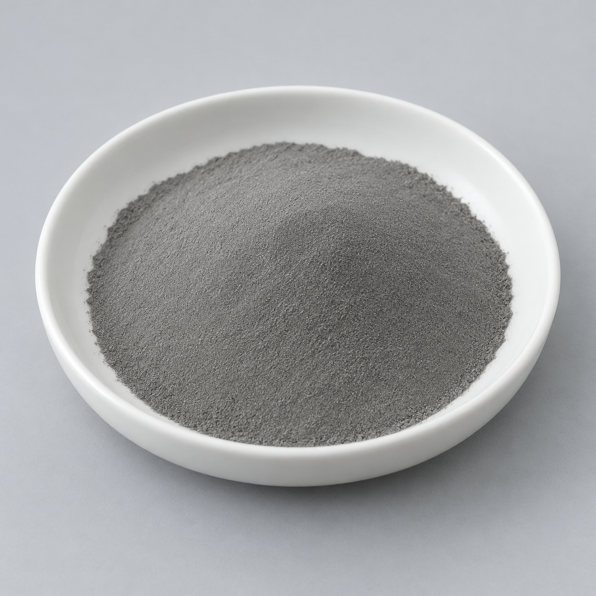 Representative image of FeCoNiCrAl High-Entropy Alloy Spherical Powder: fine matte neutral-gray FeCoNiCrAl alloy powder in a white dish