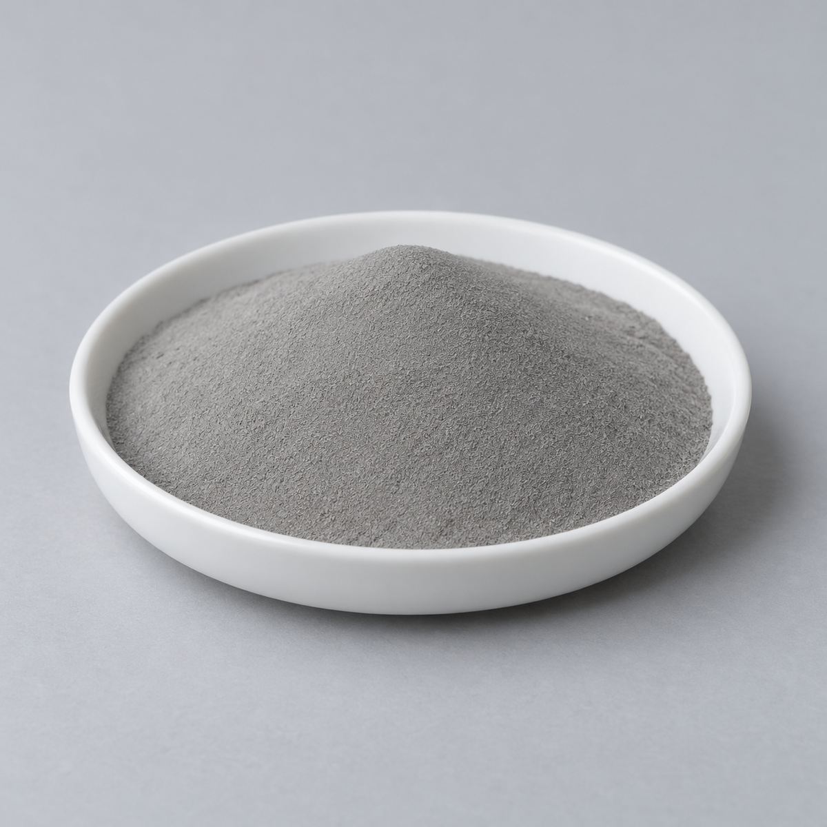 Representative image of FeCoNiCrMn High-Entropy Alloy Spherical Powder: fine matte neutral gray FeCoNiCrMn high-entropy alloy powder in a white dish